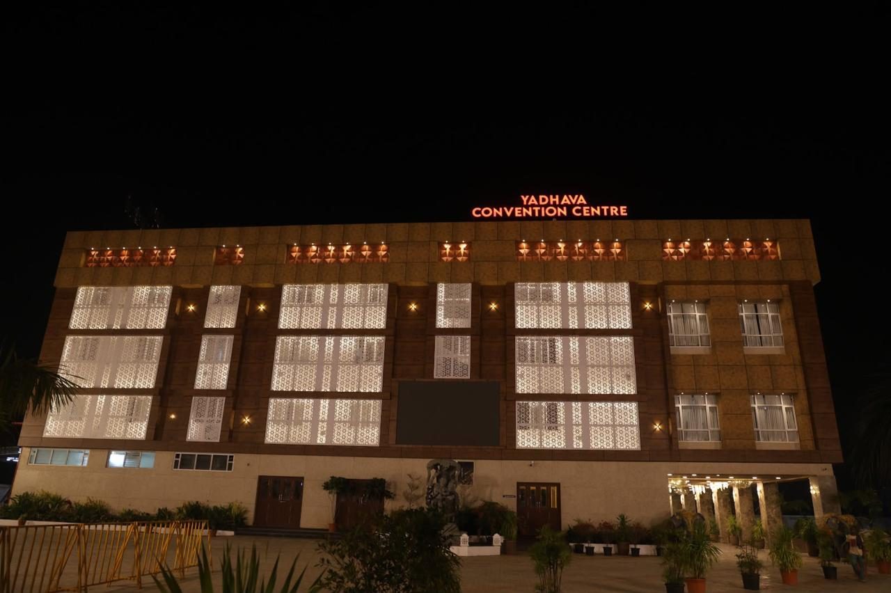 Yadhava Convention Centre building facade illuminated at night with signage