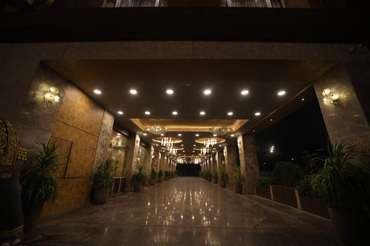Chandelier-lit arrival corridor at the entrance, photographed at night