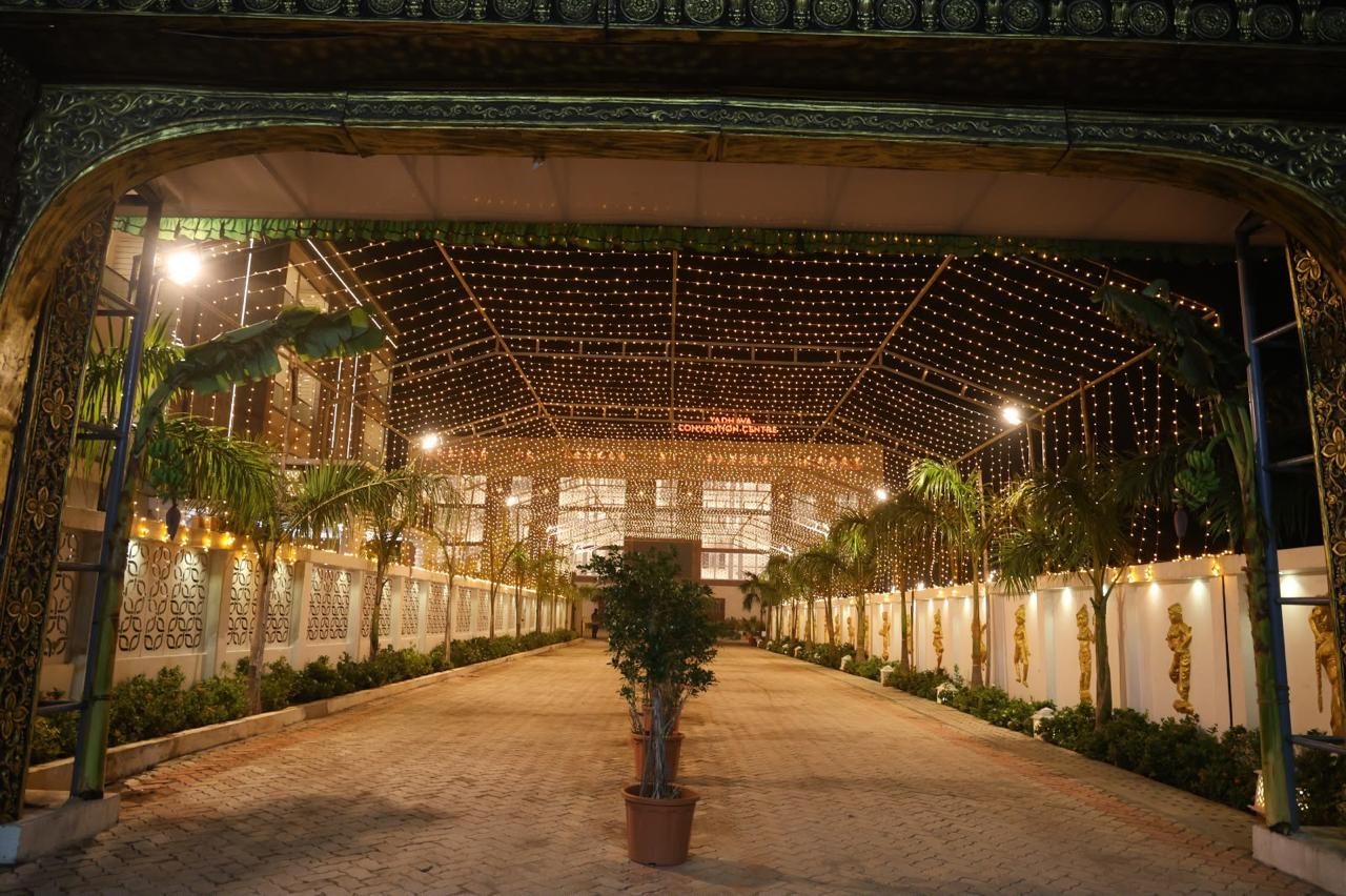 Driveway leading to the venue lit with string lights at night