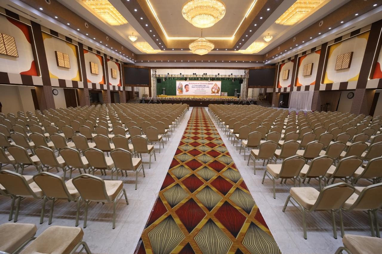 Main hall arranged with guest seating facing the stage and screens