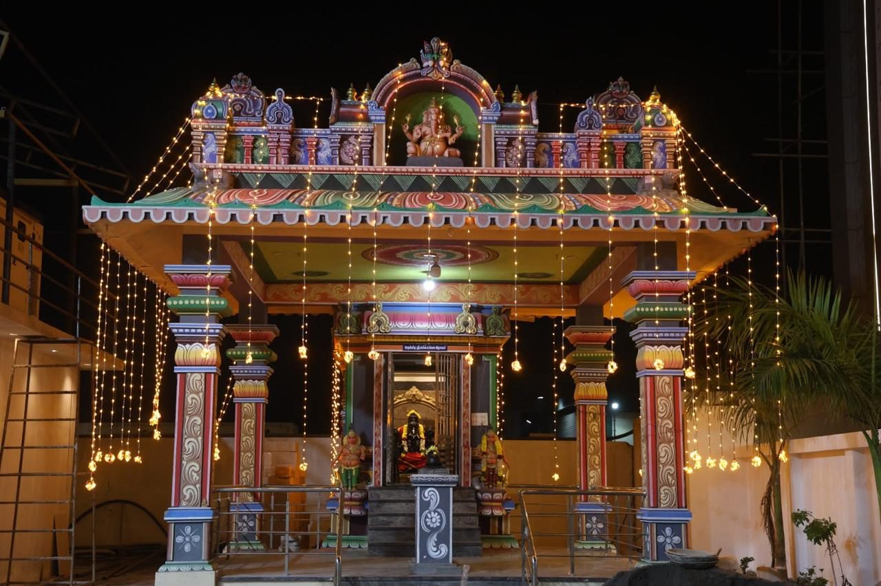 Illuminated temple shrine on the property, decorated with string lights