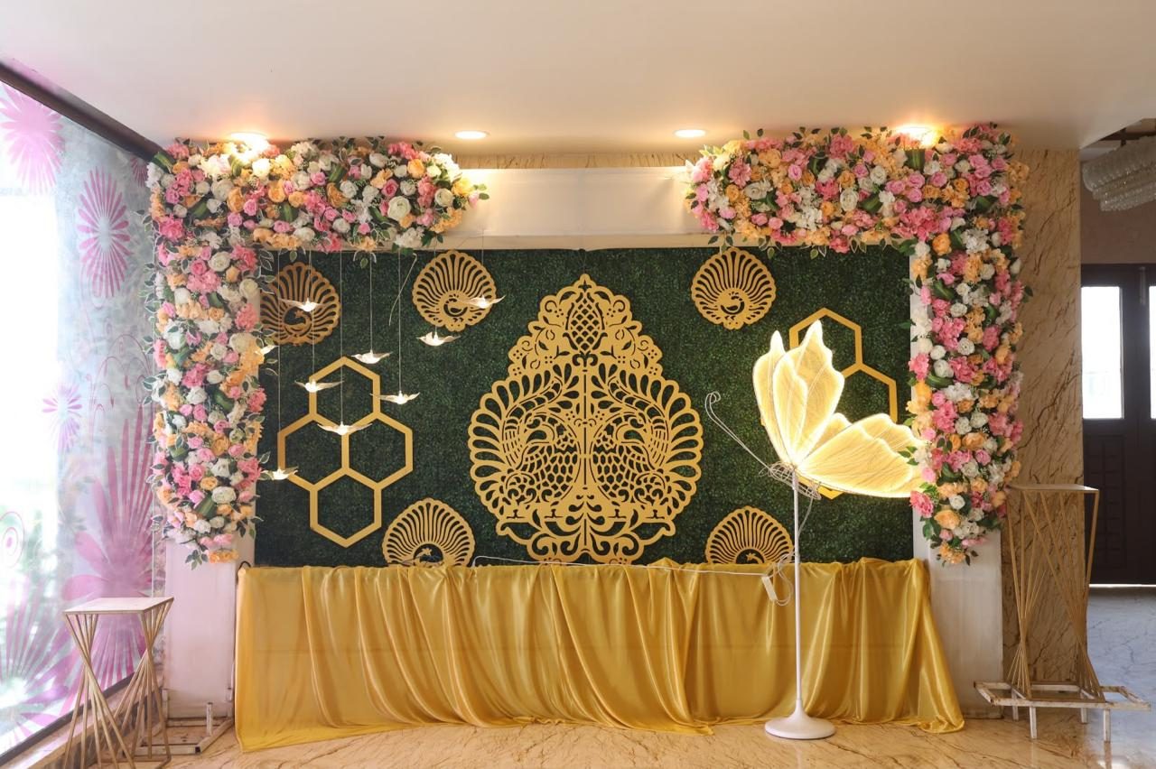 Floral wedding backdrop with gold ornamental panels and drapery