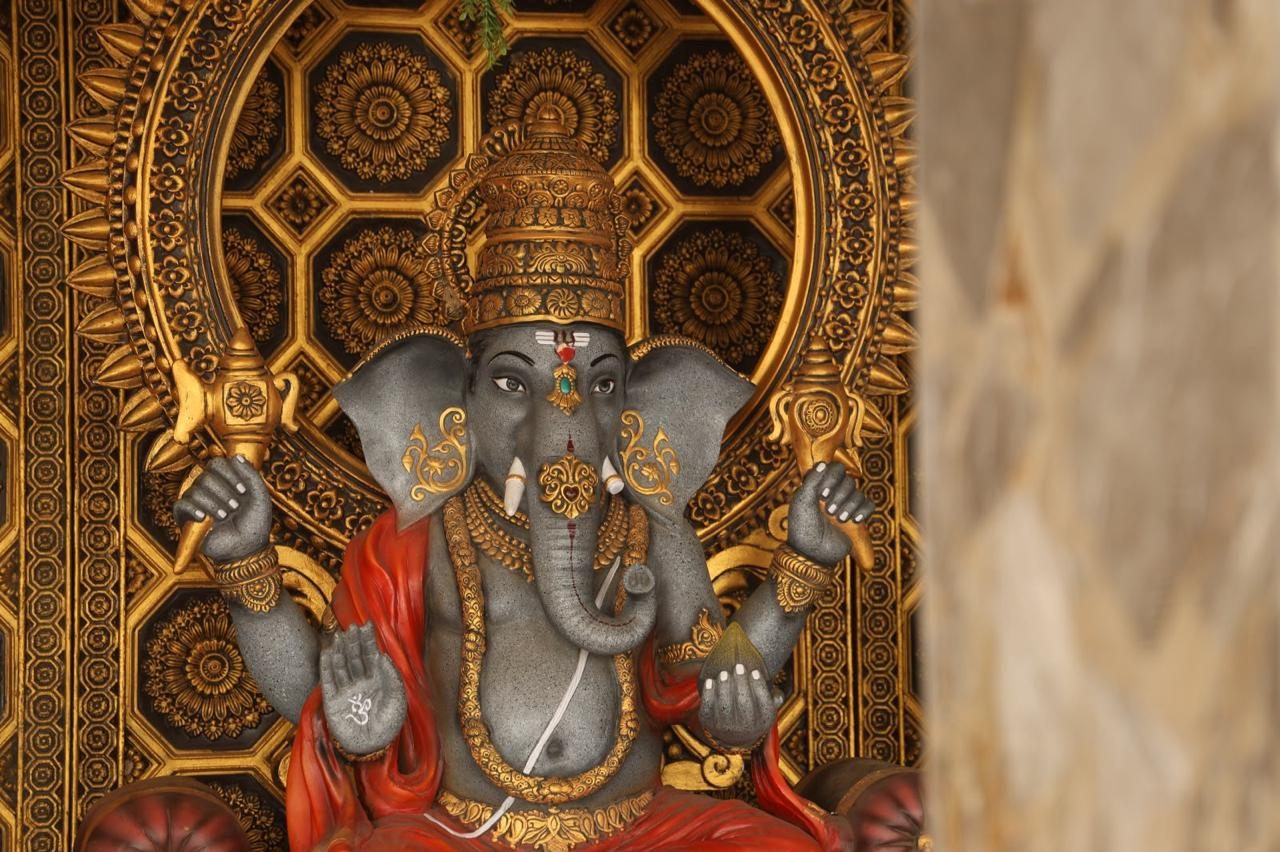 Close-up detail of a gold-adorned Ganesh idol