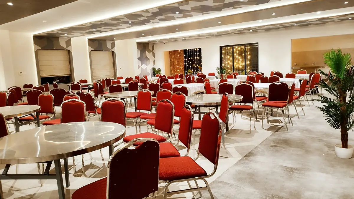 Banquet hall arranged with round tables and seating for a corporate event