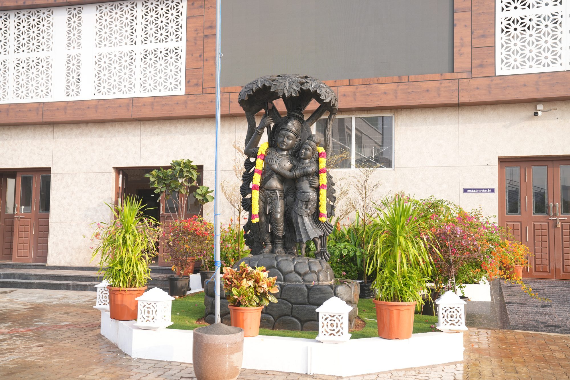Entrance facade and courtyard statue at Yadhava Convention Centre