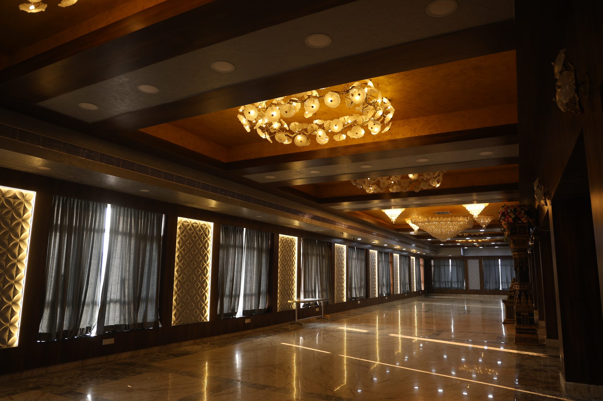 Chandelier-lit arrival corridor with valet parking at the entrance