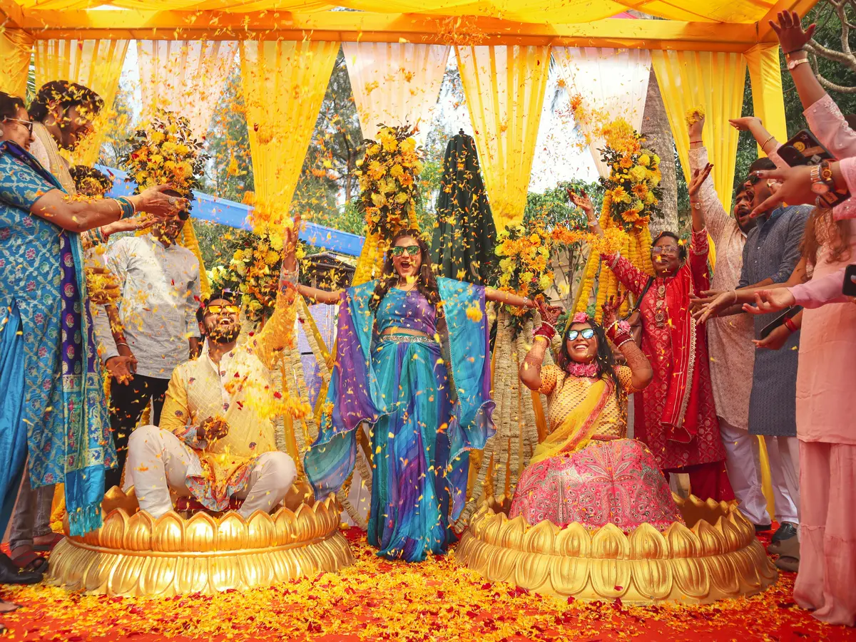 Guests celebrating with flower petals during a pre-wedding function